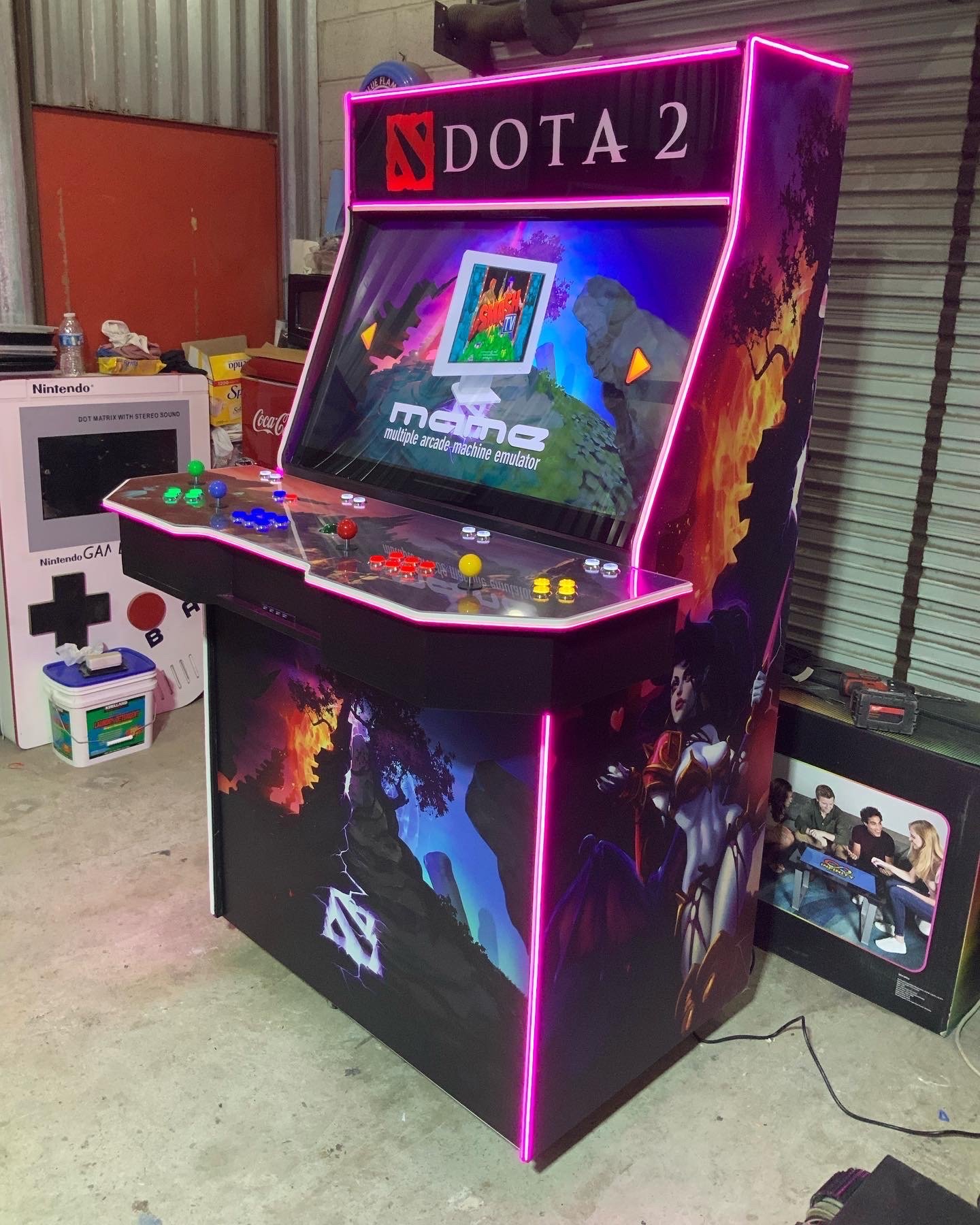 Close-up of a custom control panel with LED-lit buttons and joystick