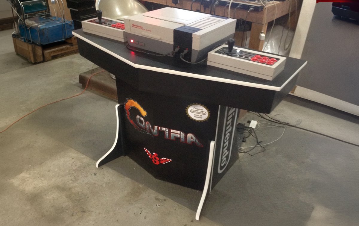 Pedestal-style arcade machine with screen mounted above a control deck